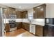 Modern kitchen with stainless appliances, granite counters, subway tile backsplash, and hardwood floors at 55 Sudderth St, Buford, GA 30518