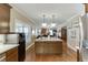 Bright open kitchen features an island, granite countertops, and leads to a spacious living area at 55 Sudderth St, Buford, GA 30518