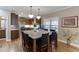 Eat-in kitchen with granite counters, pendant lighting, stainless appliances, and hardwood floors at 55 Sudderth St, Buford, GA 30518