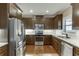 Modern kitchen boasts stainless steel appliances, granite countertops, and ample storage space at 55 Sudderth St, Buford, GA 30518