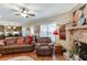 Inviting living room featuring a brick fireplace, hardwood floors and comfortable furniture at 55 Sudderth St, Buford, GA 30518