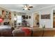 Cozy living room features a ceiling fan, fireplace, and comfortable leather seating at 55 Sudderth St, Buford, GA 30518