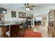 Open-concept living area featuring a bar, hardwood floors, and plenty of natural light at 55 Sudderth St, Buford, GA 30518