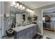 Updated bathroom with dual sinks, a granite countertop, and modern fixtures at 55 Sudderth St, Buford, GA 30518