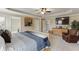 Spacious main bedroom with lounge chair, TV, and en suite access at 55 Sudderth St, Buford, GA 30518