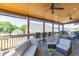 Relaxing screened in porch with ceiling fans, and comfortable outdoor seating at 55 Sudderth St, Buford, GA 30518