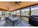 Relaxing screened in porch with ceiling fans, wood table, and chairs at 55 Sudderth St, Buford, GA 30518