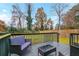 A cozy outdoor deck includes outdoor seating and a view of a green backyard at 8451 Magnolia Dr, Jonesboro, GA 30238