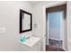 Bathroom showcasing a vanity with sink, mirror, and a view into the hallway at 8451 Magnolia Dr, Jonesboro, GA 30238