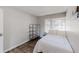 This bedroom offers a bright window, wood-look flooring, and a modern metal shelving unit at 8451 Magnolia Dr, Jonesboro, GA 30238