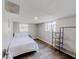 Bedroom with laminate floor, natural light, and modern shelving at 8451 Magnolia Dr, Jonesboro, GA 30238