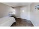 Bedroom with wood-look floors, natural light, and modern shelving at 8451 Magnolia Dr, Jonesboro, GA 30238