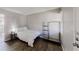 This simple bedroom has wood-look flooring and a white door at 8451 Magnolia Dr, Jonesboro, GA 30238