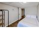 A simple bedroom offers wood-look flooring and a white door leading to another room at 8451 Magnolia Dr, Jonesboro, GA 30238