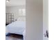 This bedroom features wood-look flooring, a bright window, and a modern metal shelving unit at 8451 Magnolia Dr, Jonesboro, GA 30238
