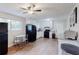 Bright kitchen with white cabinets, stainless appliances, laminate floors, and an adjacent eating area at 8451 Magnolia Dr, Jonesboro, GA 30238