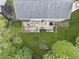 Aerial view of home with a lovely back deck with outdoor seating and stairway to the backyard at 10090 Feather Sound Ct, Alpharetta, GA 30022