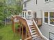Lovely home back deck with outdoor seating and stairway to the backyard and a serene place for outdoor relaxation at 10090 Feather Sound Ct, Alpharetta, GA 30022