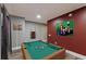 Basement with pool table, gray wood floors, and wine rack at 10090 Feather Sound Ct, Alpharetta, GA 30022