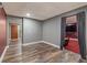 Versatile basement space with wood-look floors and adjacent entertainment area at 10090 Feather Sound Ct, Alpharetta, GA 30022
