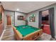 Finished basement with a pool table, darts and an adjacent entertainment area at 10090 Feather Sound Ct, Alpharetta, GA 30022