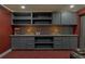 Basement entertainment area with gray built-ins and granite counters at 10090 Feather Sound Ct, Alpharetta, GA 30022