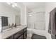 Bright bathroom with granite countertop, updated vanity, and tub-shower combination at 10090 Feather Sound Ct, Alpharetta, GA 30022