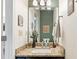 Bathroom featuring granite counters, modern lighting, vanity mirror, and decorative artwork at 10090 Feather Sound Ct, Alpharetta, GA 30022