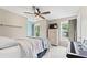 Bright bedroom with large windows, ceiling fan, and neutral decor at 10090 Feather Sound Ct, Alpharetta, GA 30022