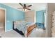 Cozy bedroom featuring a ceiling fan, and a light blue painted accent wall at 10090 Feather Sound Ct, Alpharetta, GA 30022
