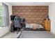 Bedroom featuring a brick accent wall, ceiling fan, and great natural light at 10090 Feather Sound Ct, Alpharetta, GA 30022
