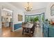 Open dining room with a view of the kitchen featuring a charming bay window at 10090 Feather Sound Ct, Alpharetta, GA 30022