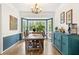 Bright dining room with bay window and rustic wooden table at 10090 Feather Sound Ct, Alpharetta, GA 30022
