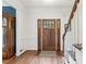 Entryway featuring hardwood floors, a wooden front door with glass panes, and stairs to the upper level at 10090 Feather Sound Ct, Alpharetta, GA 30022