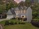 Charming two-story home with landscaped yard, inviting front porch and attached two car garage at 10090 Feather Sound Ct, Alpharetta, GA 30022