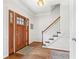 Bright foyer featuring hardwood floors, a wooden door and a staircase with white risers at 10090 Feather Sound Ct, Alpharetta, GA 30022