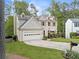 Beautiful two-story home with a well-maintained lawn and garden, showcasing its curb appeal and inviting ambiance at 10090 Feather Sound Ct, Alpharetta, GA 30022
