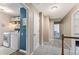 Hallway view of laundry room featuring a full-size washer, dryer, and convenient shelf storage at 10090 Feather Sound Ct, Alpharetta, GA 30022
