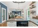 Bright kitchen featuring granite counters, stainless steel appliances, and open concept design to the living room at 10090 Feather Sound Ct, Alpharetta, GA 30022