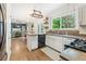 Well-lit kitchen with white cabinets, granite countertops, and open layout at 10090 Feather Sound Ct, Alpharetta, GA 30022