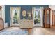Charming living room featuring hardwood floors, large windows, and classic furnishings at 10090 Feather Sound Ct, Alpharetta, GA 30022