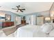 Bright main bedroom boasts a ceiling fan, ensuite bath access, and natural light at 10090 Feather Sound Ct, Alpharetta, GA 30022