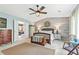 Charming main bedroom featuring a wood accent wall, ceiling fan, and ensuite bath at 10090 Feather Sound Ct, Alpharetta, GA 30022