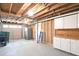 Unfinished basement featuring a utility sink, cabinets, and access to a garage at 1140 Starline Se Dr, Smyrna, GA 30080