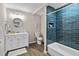 Modern bathroom featuring blue tiled shower and updated vanity at 1140 Starline Se Dr, Smyrna, GA 30080