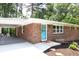 Beautiful brick home featuring a charming front door and a covered carport with comfortable seating at 1140 Starline Se Dr, Smyrna, GA 30080