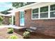 Eye-catching brick exterior with a cheerful blue front door, bench, and lovely landscaping at 1140 Starline Se Dr, Smyrna, GA 30080