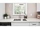 Kitchen sink area with bright window view and gray tile backsplash at 1140 Starline Se Dr, Smyrna, GA 30080