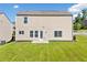 Back view of home with a large yard at 1560 Avalon Creek Rd, Sugar Hill, GA 30518