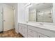 Bathroom with double vanity, updated fixtures, and a large mirror at 1560 Avalon Creek Rd, Sugar Hill, GA 30518